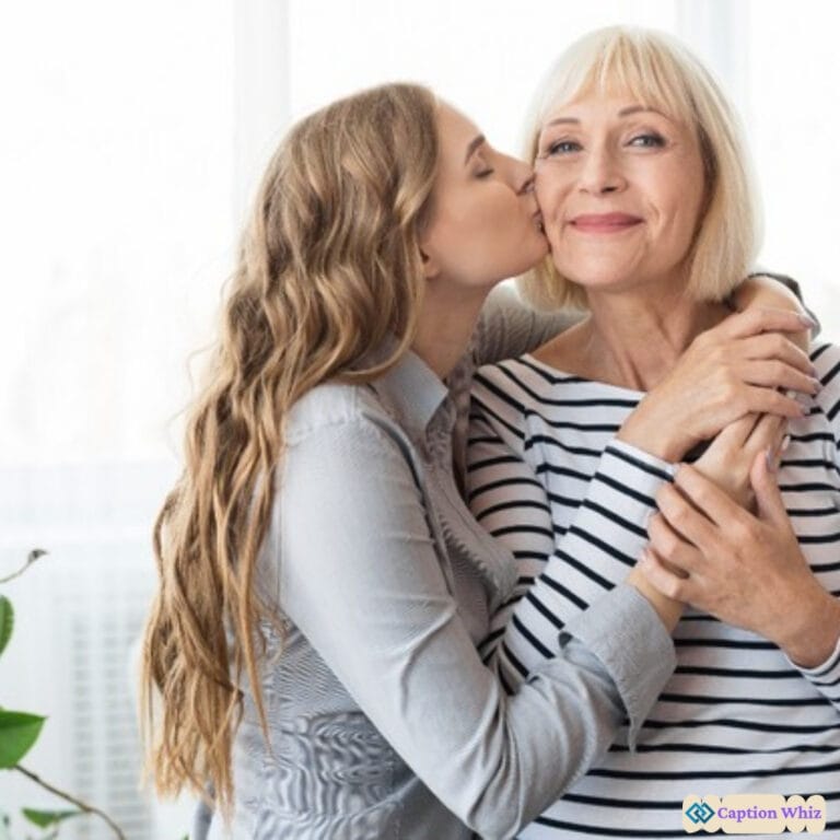 A young woman kisses her smiling mother on the cheek, both radiating joy in a bright room.