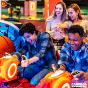 Four friends joyfully playing an arcade basketball game, with smiles and excitement in the air.
