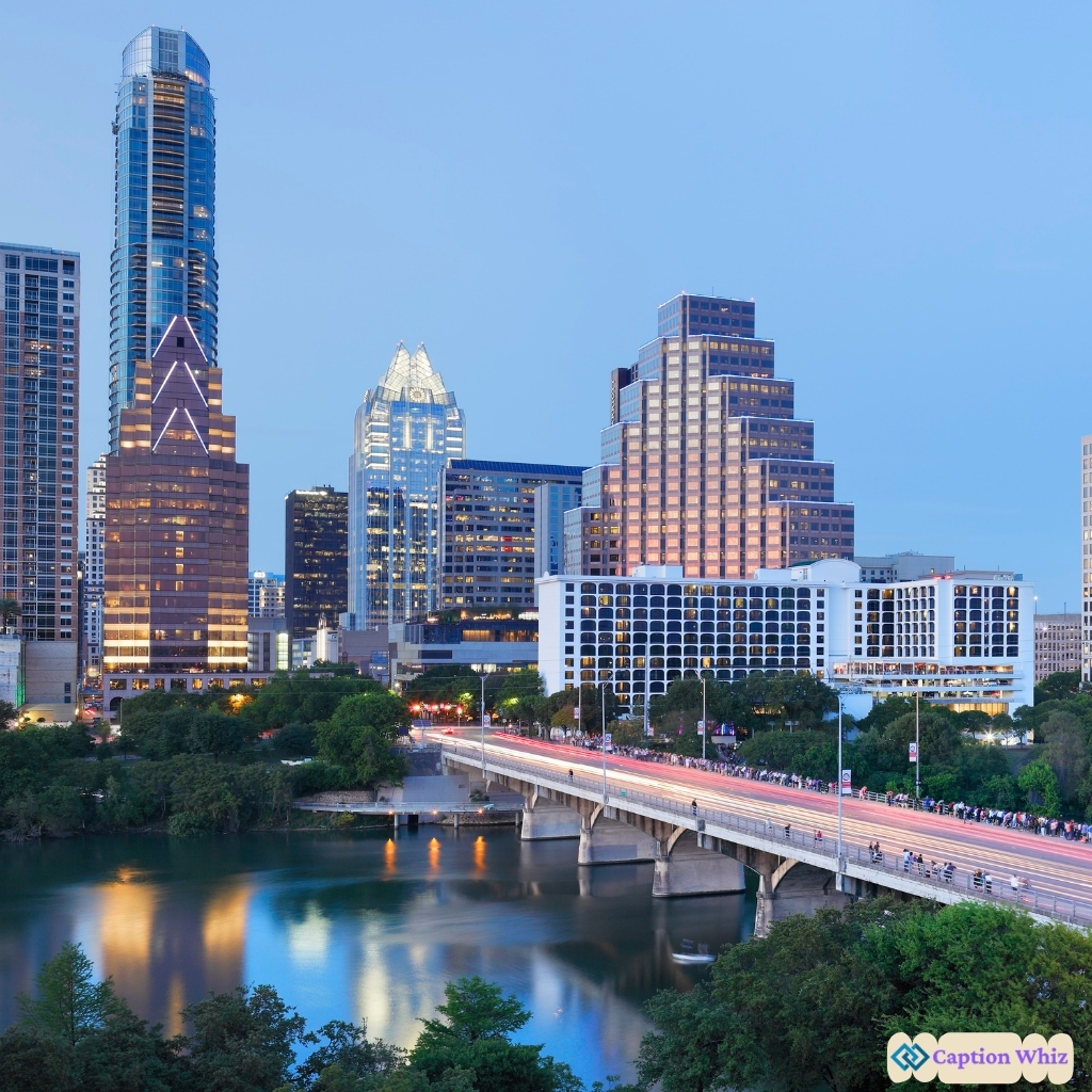 Austin skyline at dusk with bridges and reflections on the water.