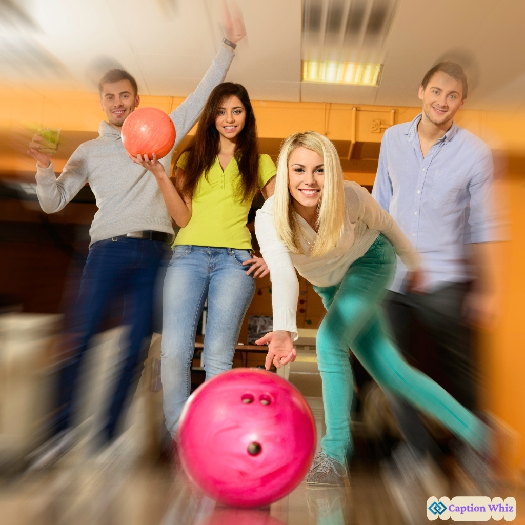 Four friends having fun at a bowling alley, one bowling with a pink ball.